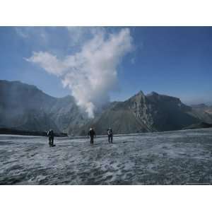  Hikers Cross a Plain with Smoldering Volcanoes in the 