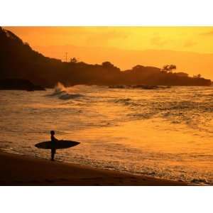  Surfer Standing at Waimea Bay at Sunset, Waimea, U.S.A 