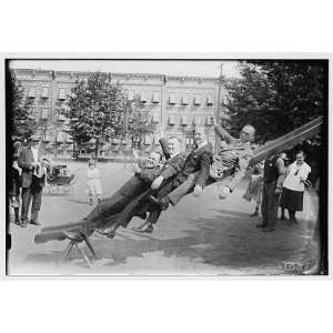  4 men on slide in park