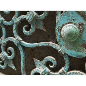 Close Up of Detailed Rusty Metal Gate Woven around Doorknob Stretched 